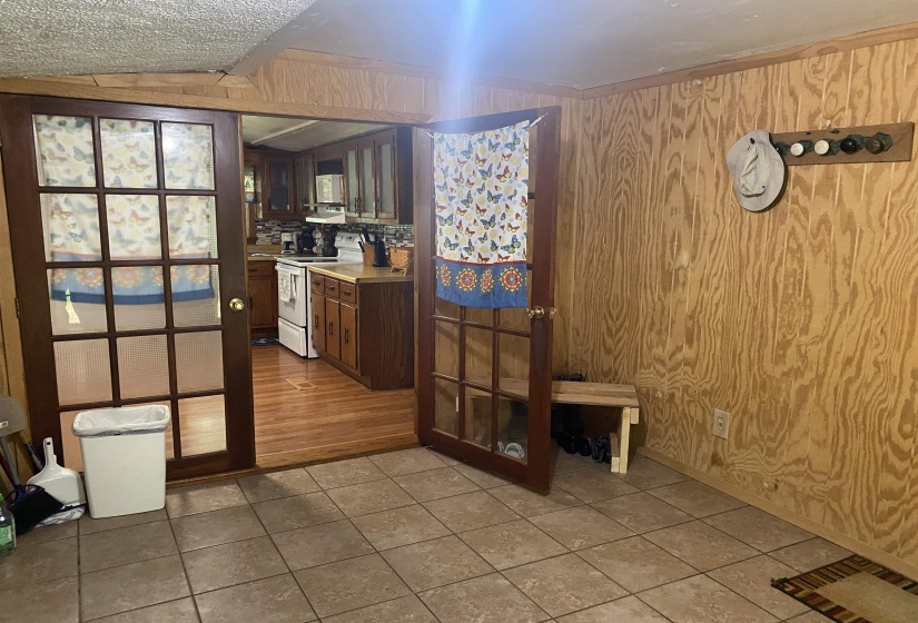 Kitchen featuring electric stove, tile patterned flooring, and light countertops