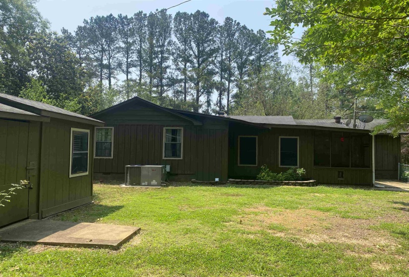 Rear view of house with a lawn and board and batten siding