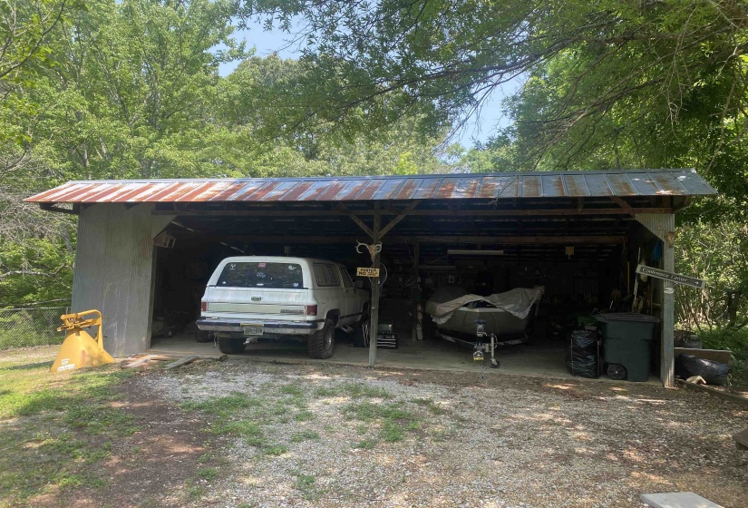View of parking / parking lot with a carport