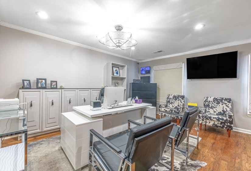 Interior space featuring ornamental molding and light hardwood / wood-style flooring