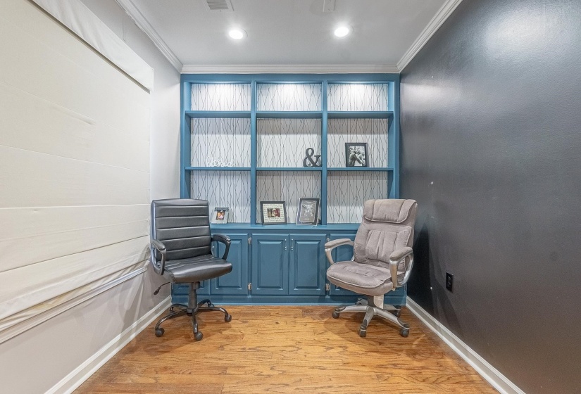 Living area featuring ornamental molding and light wood-type flooring