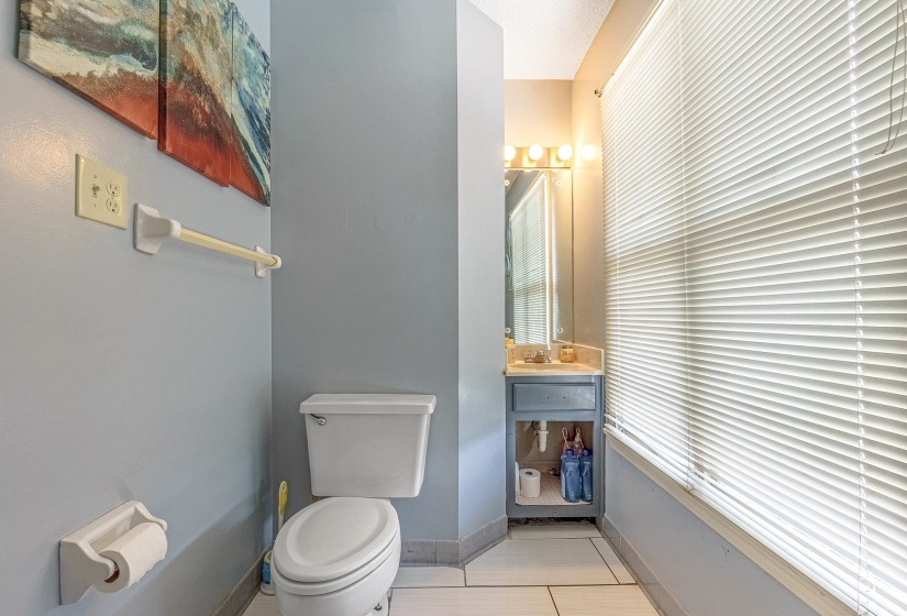 Bathroom featuring tile patterned floors, toilet, and vanity