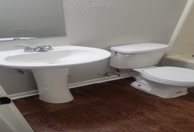 Bathroom with sink, hardwood / wood-style floors, and toilet