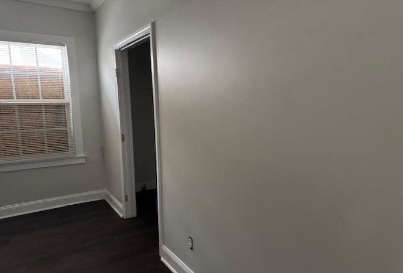 Corridor with dark hardwood / wood-style flooring