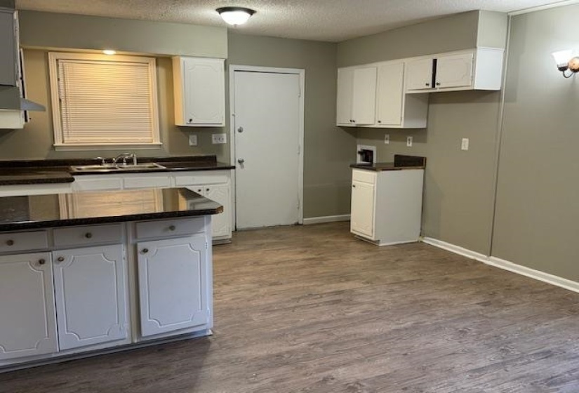Kitchen featuring white cabinetry, dark hardwood / wood-style floors, and sink