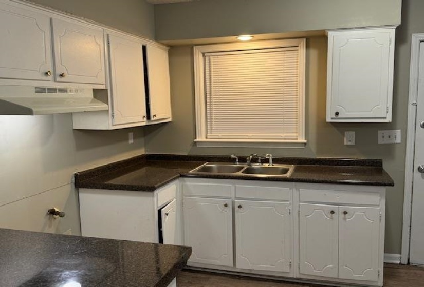 Kitchen featuring sink and white cabinetry