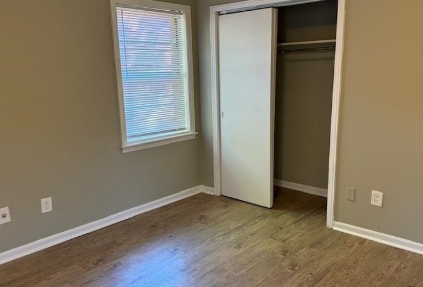 Unfurnished bedroom with a closet and hardwood / wood-style floors