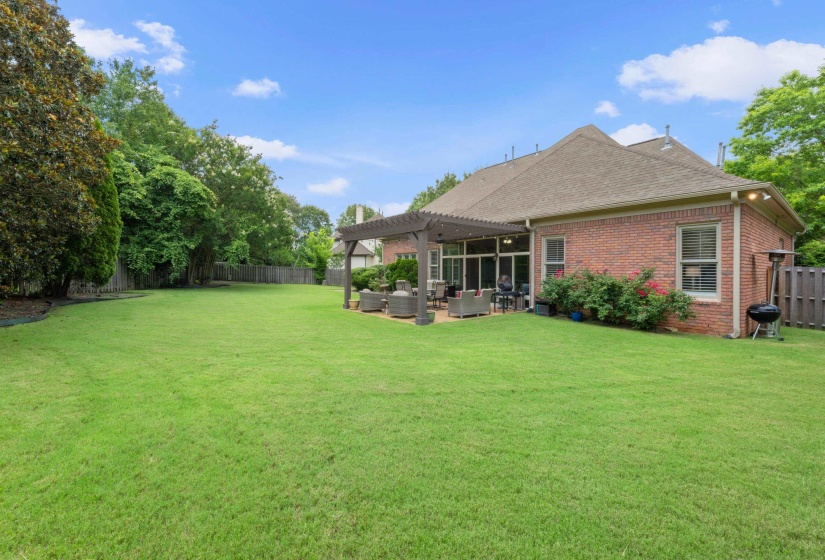 Fenced backyard with a pergola, outdoor lounge area, and a patio