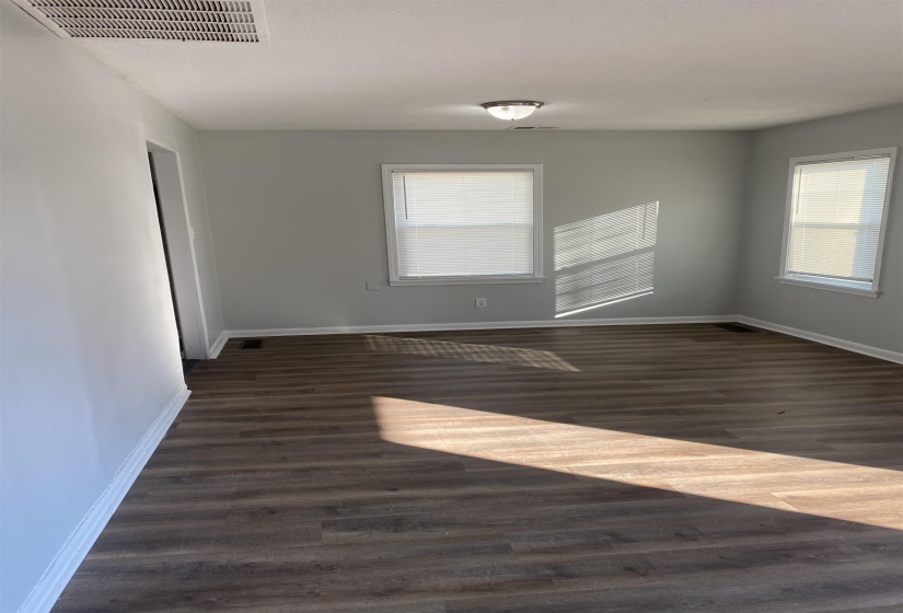 Empty room with dark wood-type flooring