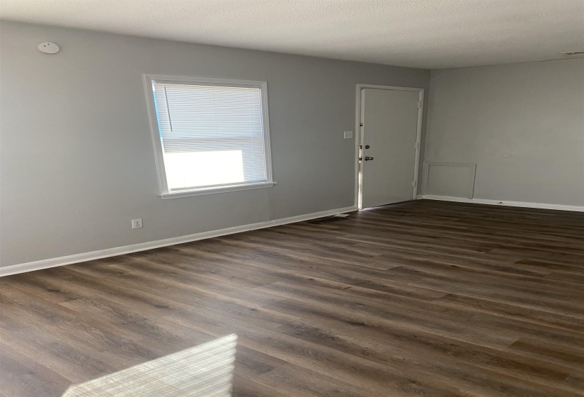 Empty room featuring dark hardwood / wood-style floors