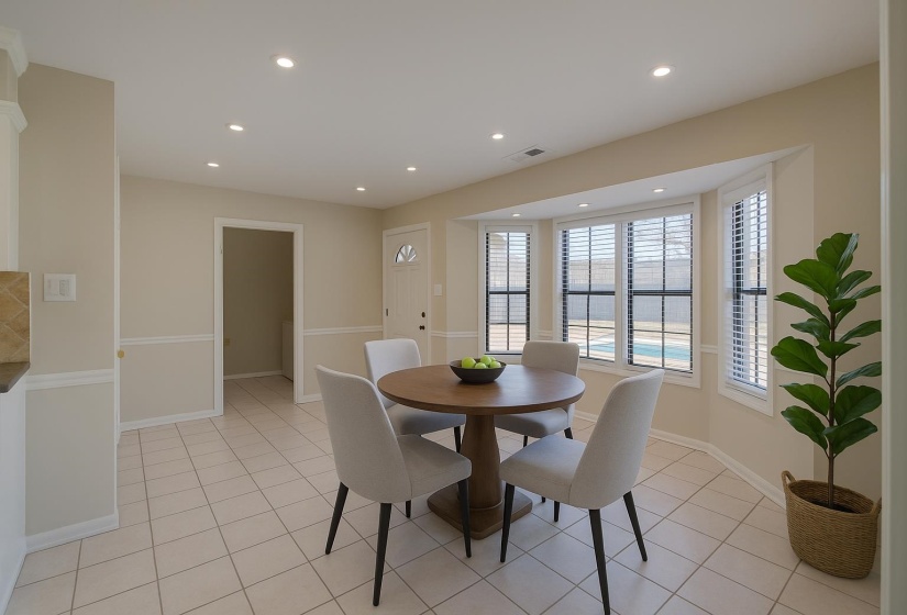 Dining room featuring recessed lighting and light tile patterned floors. This photo is digitally staged.