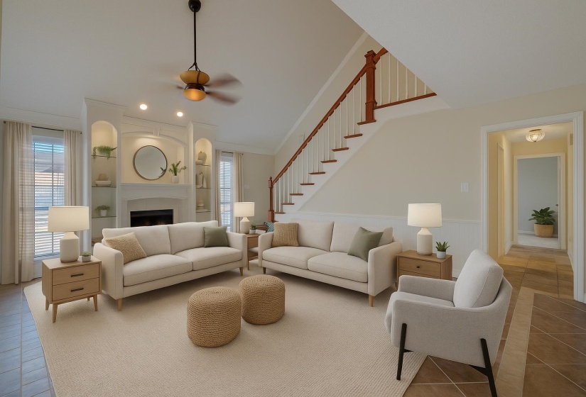 Living area with tile patterned flooring, a fireplace, ornamental molding, ceiling fan, and lofted ceiling. This photo is digitally staged.