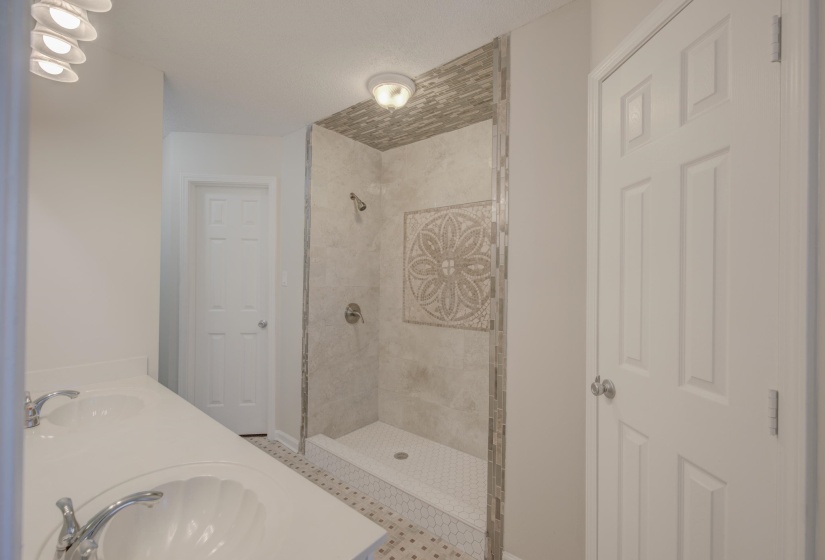 Bathroom with a tile shower and sink
