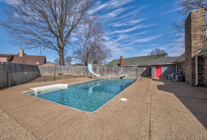 View of swimming pool featuring a patio, central AC unit, a diving board, and a water slide