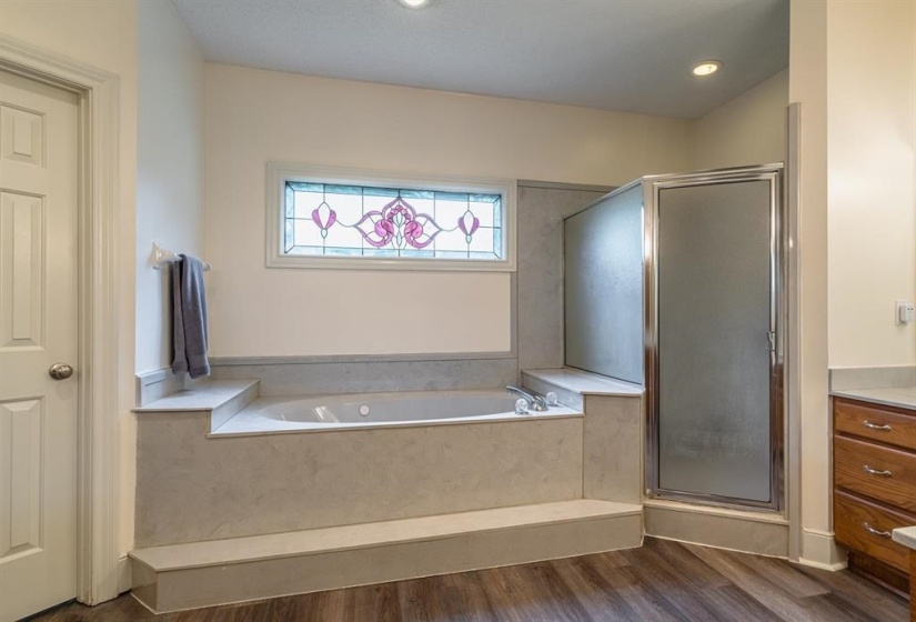 Bathroom with wood-type flooring and independent shower and bath