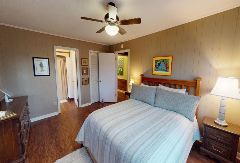 Bedroom with ceiling fan, dark hardwood / wood-style floors, and crown molding