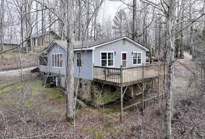 Back of property featuring a wooden deck