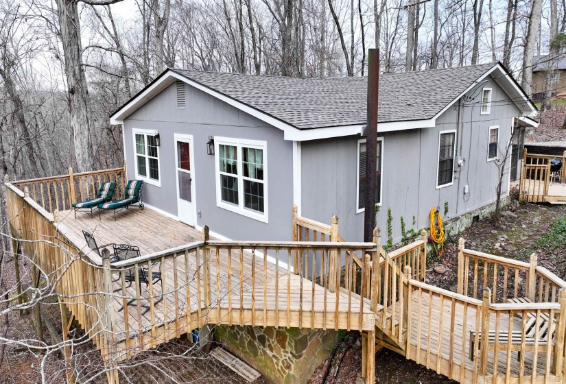 Back of house with a deck