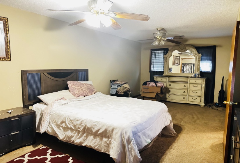Bedroom featuring ceiling fan and carpet