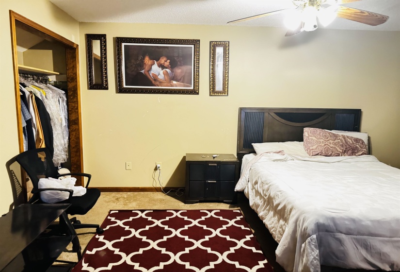 Bedroom with carpet, ceiling fan, and a closet
