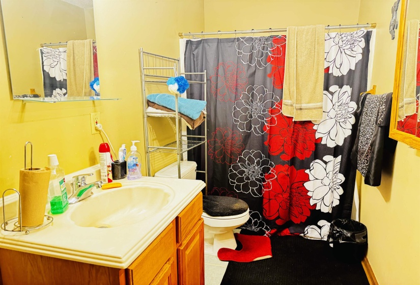 Bathroom with tile patterned flooring, vanity, toilet, and a shower with shower curtain