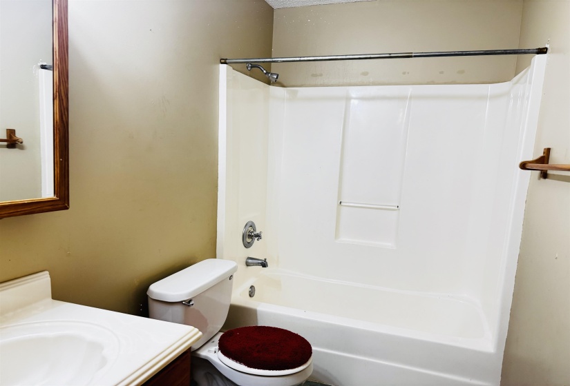 Full bathroom featuring vanity, shower / bathtub combination, and toilet