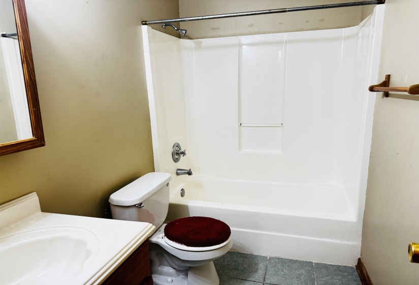 Full bathroom with tile patterned floors, vanity, toilet, and bathtub / shower combination