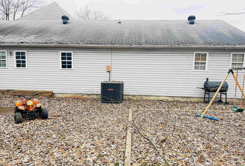 View of side of property featuring cooling unit