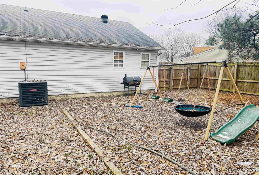 Exterior space featuring a playground and central AC unit