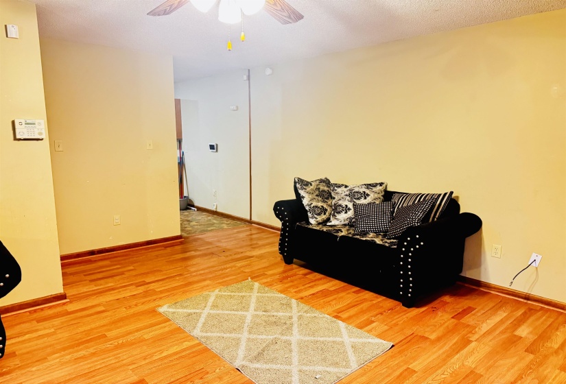 Sitting room with hardwood / wood-style flooring and ceiling fan