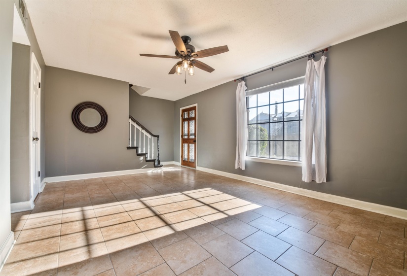 Interior space with light tile patterned floors and ceiling fan