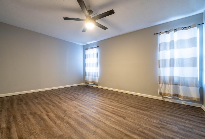 Spare room with ceiling fan and dark hardwood / wood-style floors