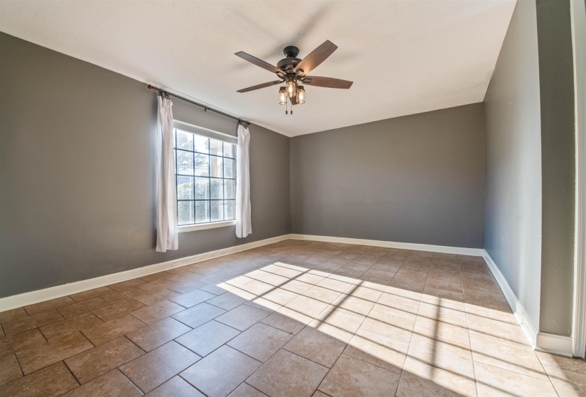 Unfurnished room with ceiling fan and light tile patterned floors