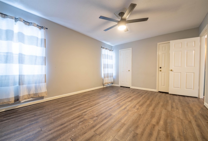 Unfurnished bedroom featuring ceiling fan and wood-type flooring