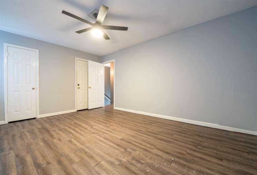 Unfurnished bedroom with hardwood / wood-style floors and ceiling fan