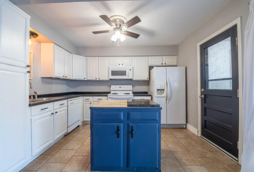 Kitchen featuring a center island, white cabinetry, white appliances, and sink