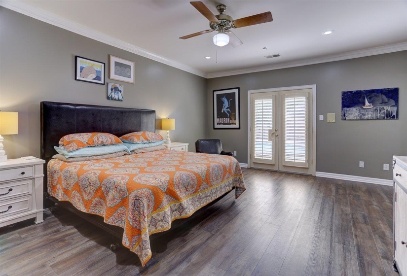 Bedroom featuring baseboards, access to outside, dark wood-style floors, and visible vents