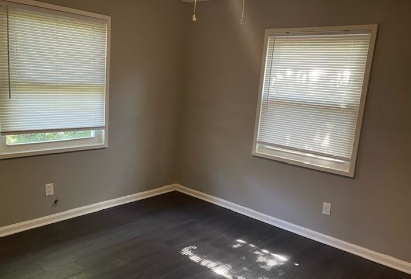 Spare room featuring dark wood-type flooring