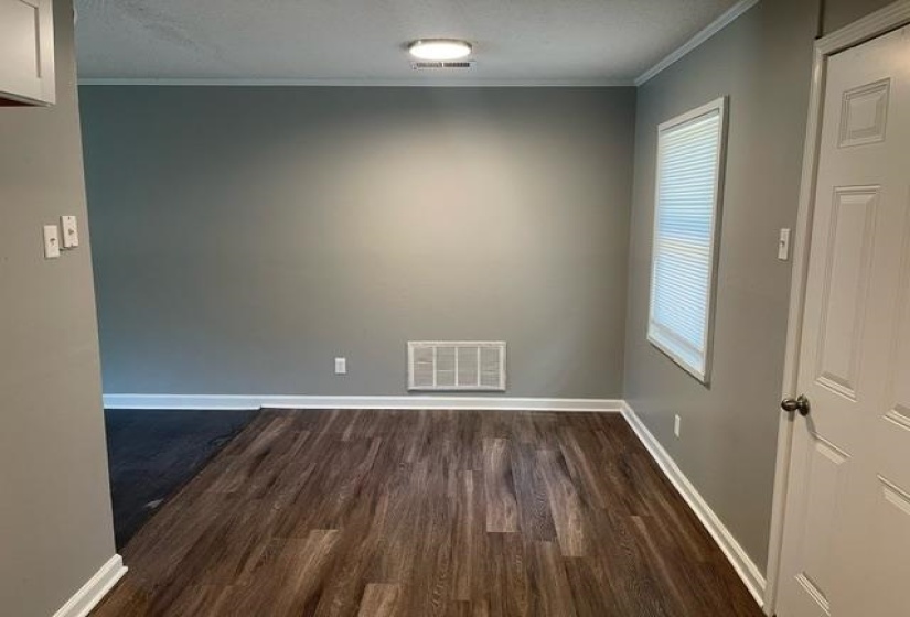 Spare room featuring ornamental molding, dark hardwood / wood-style flooring, and a healthy amount of sunlight