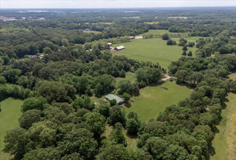 Drone / aerial view featuring a wooded view and a rural view