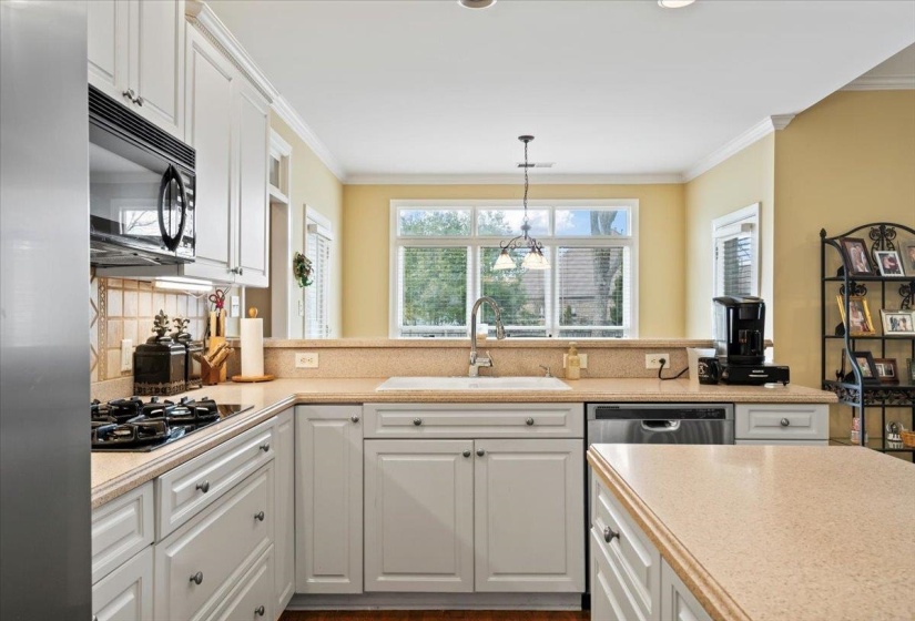 Kitchen with sink, white cabinetry, and gas cooktop