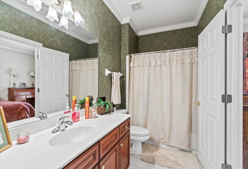 Bathroom with toilet, tile patterned floors, ornamental molding, a shower with curtain, and vanity