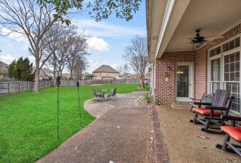 View of yard featuring ceiling fan and a patio