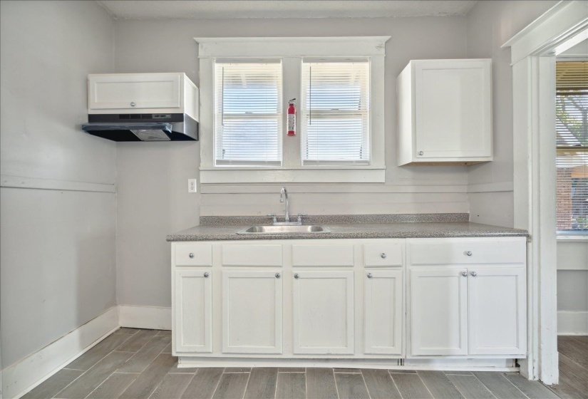 Kitchen with white cabinets and sink