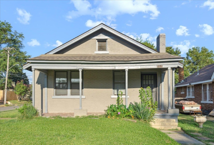 Bungalow-style home featuring a front lawn and a porch