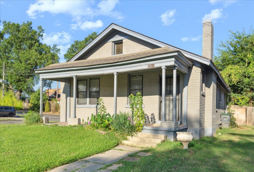 View of front of home featuring a front yard and a porch