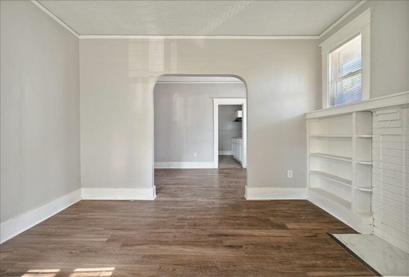 Spare room featuring dark hardwood / wood-style floors and ornamental molding