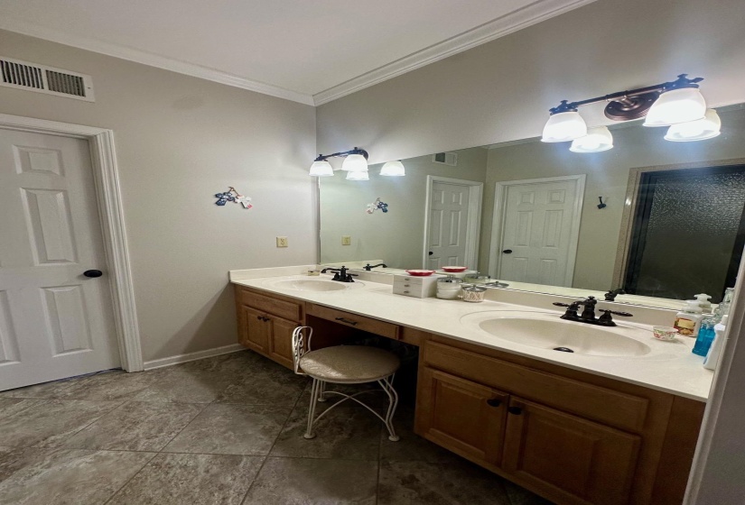 Bathroom featuring vanity and ornamental molding