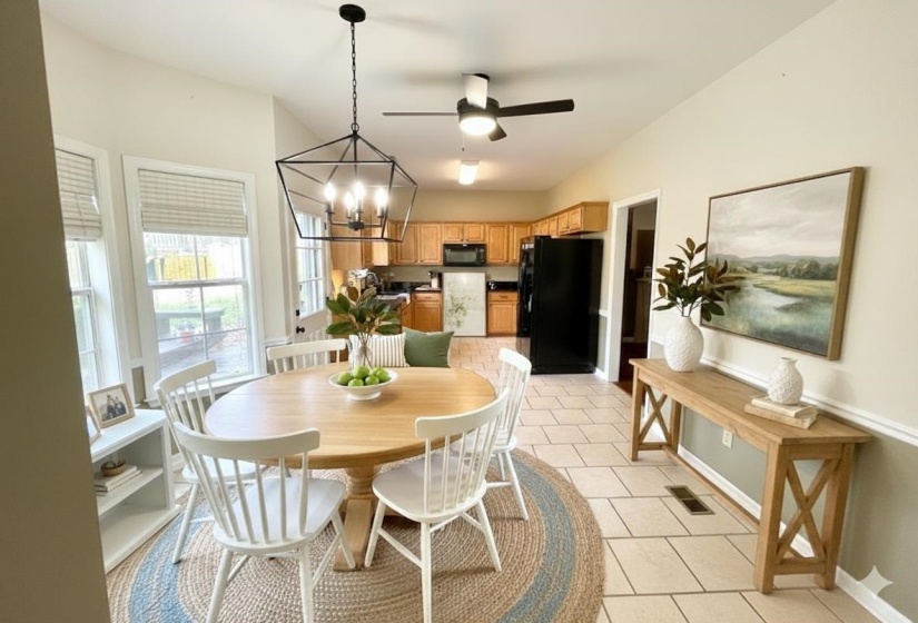 VIRTUALLY STAGED Dining room featuring a chandelier, light tile patterned flooring, and ceiling fan