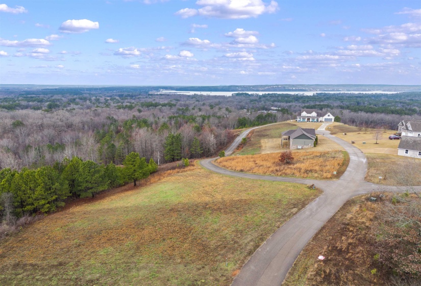 Bird's eye view of a nearby body of water and a heavily wooded area